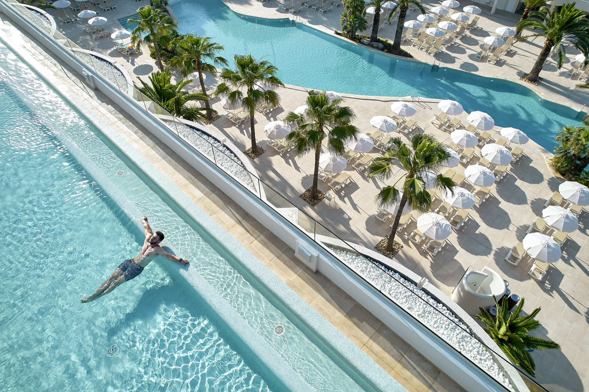 Relaxed swimmer floating in luxury resort pool