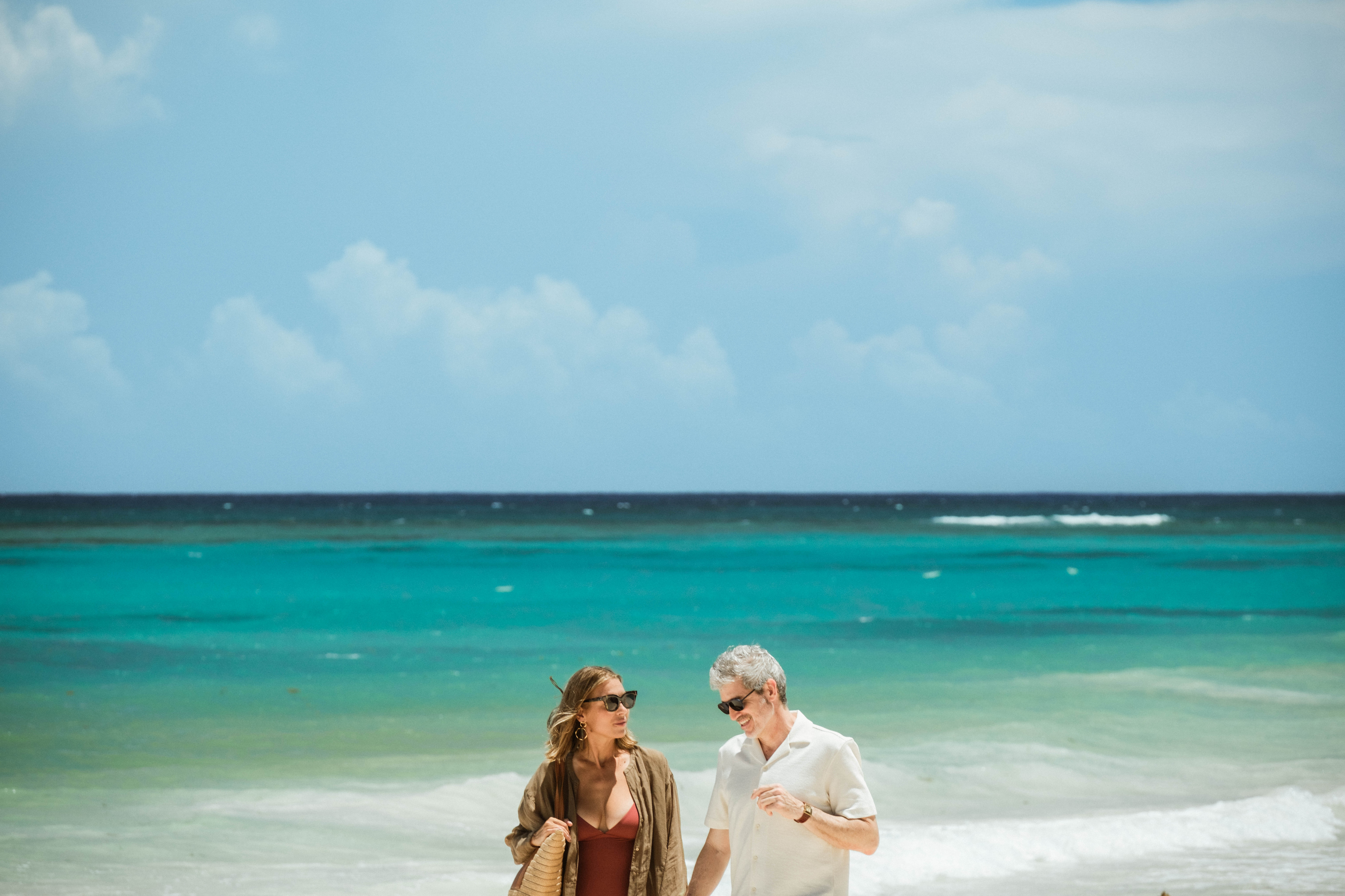 Mature Couple Walking Together on Tropical Beach