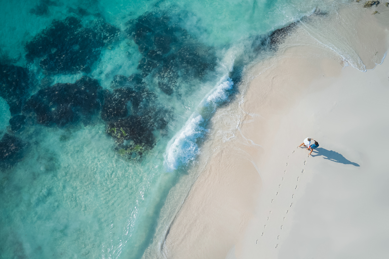 Aerial view of person walking tropical beach